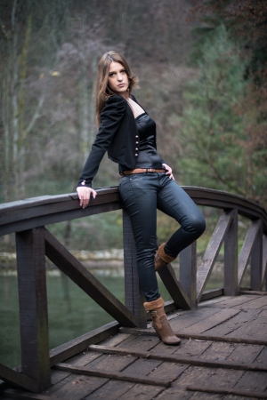 young woman leaning at the bridgeの写真素材