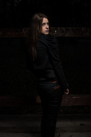 young woman looking behind her shoulderの写真素材