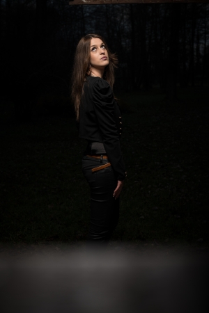 young woman looking behind her shoulder and looking upの写真素材