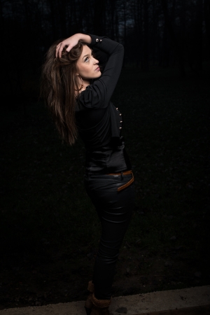 young woman looking up behind her shoulderの写真素材