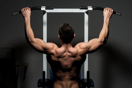 young male bodybuilder doing heavy weight exerciseの写真素材