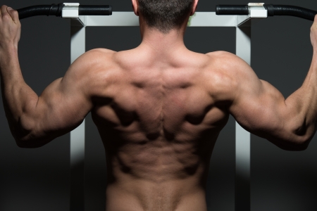 young male bodybuilder doing heavy weight exerciseの写真素材