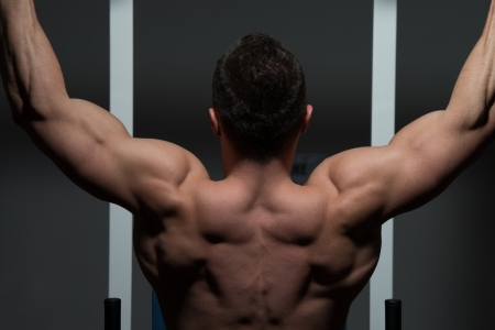 young male bodybuilder doing heavy weight exerciseの写真素材