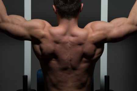 young male bodybuilder doing heavy weight exerciseの写真素材