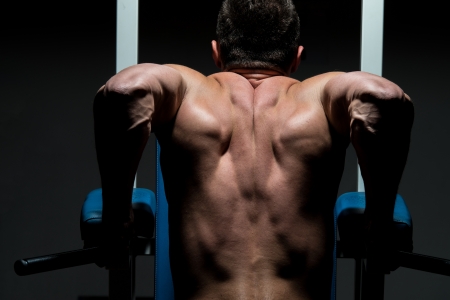 young male bodybuilder doing heavy weight exerciseの写真素材