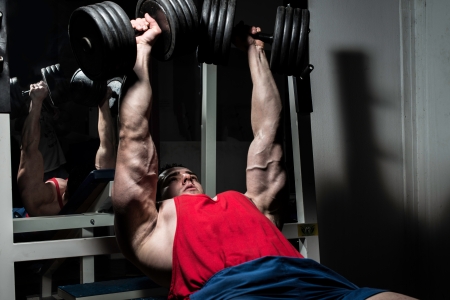 young bodybuilder doing bench press for chestの写真素材