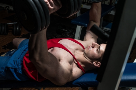 young bodybuilder doing bench press for chestの写真素材
