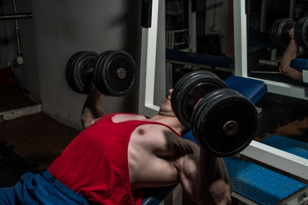 young bodybuilder doing bench press for chestの写真素材