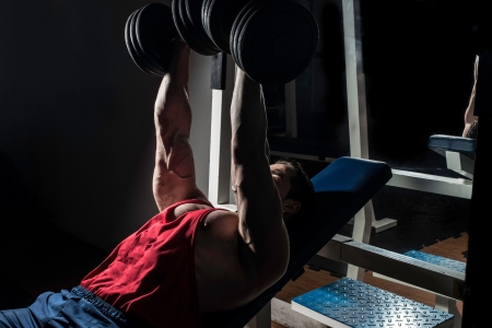 young bodybuilder doing bench press for chestの写真素材