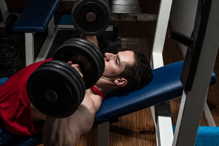 young bodybuilder doing bench press for chestの写真素材