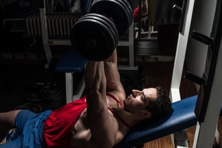 young bodybuilder doing bench press for chestの写真素材