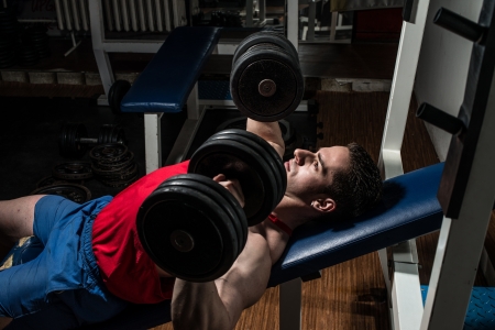 young bodybuilder doing bench press for chestの写真素材