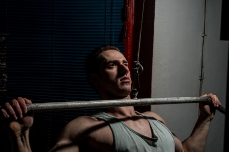 young body builder doing heavy weight exercise for backの写真素材