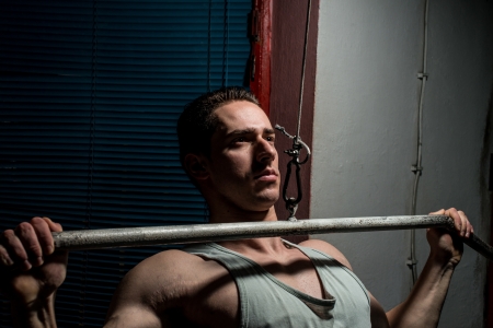 young body builder doing heavy weight exercise for backの写真素材