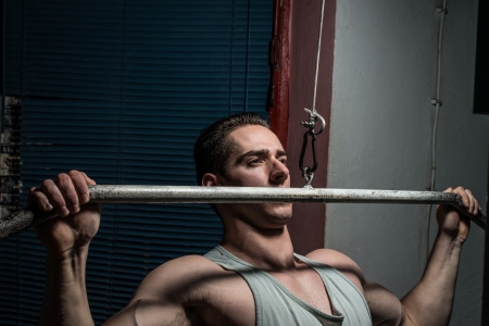 young body builder doing heavy weight exercise for backの写真素材