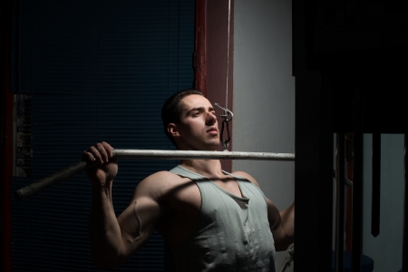 young body builder doing heavy weight exercise for backの写真素材