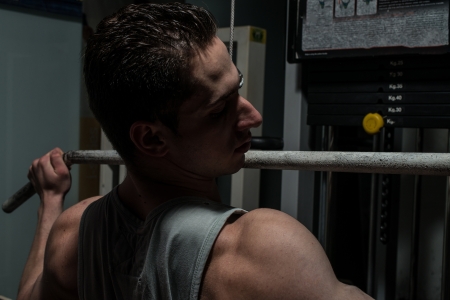 young body builder doing heavy weight exercise for backの写真素材