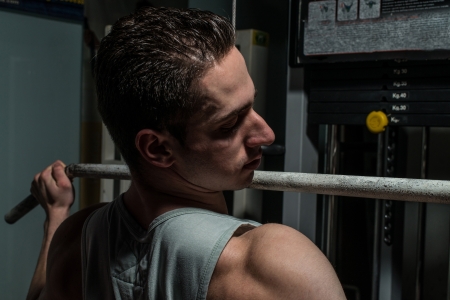young body builder doing heavy weight exercise for backの写真素材