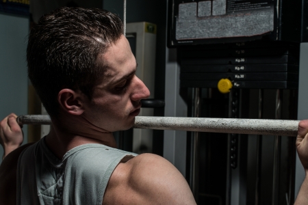 young body builder doing heavy weight exercise for backの写真素材