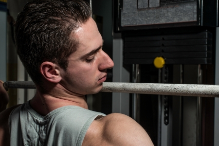 young body builder doing heavy weight exercise for backの写真素材