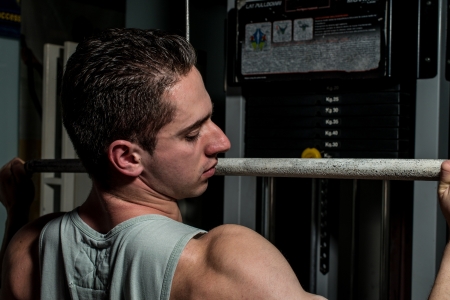 young body builder doing heavy weight exercise for backの写真素材