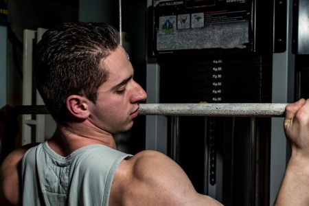 young body builder doing heavy weight exercise for backの写真素材