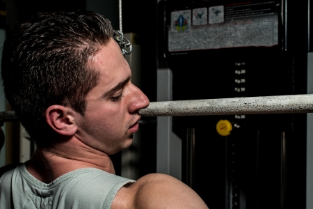 young body builder doing heavy weight exercise for backの写真素材