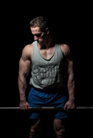 bodybuilder posing on black backgroundの写真素材