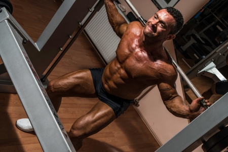 bodybuilder doing squat with barbellの写真素材