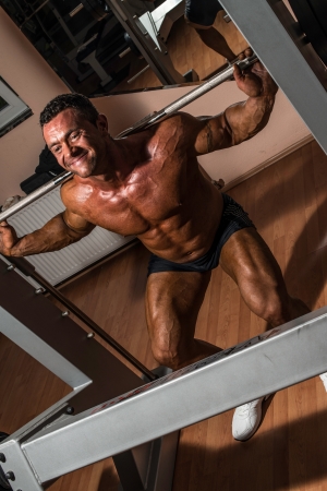 bodybuilder doing squat with barbellの写真素材