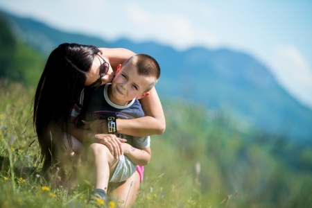 mother kissing her child on the cheekの写真素材