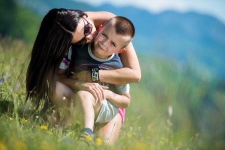 mother kissing her child on the cheekの写真素材