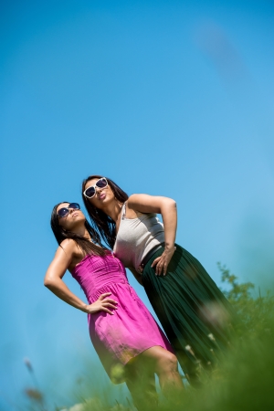 two girls in dress having funの写真素材