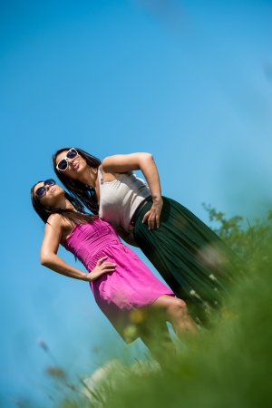 two girls in dress having funの写真素材