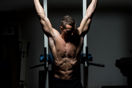handsome man exercising his abs at the gymの写真素材