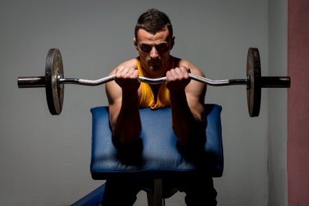 fitness trainer doing heavy weight exercise for bicepsの写真素材
