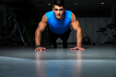 Healthy young guy doing push up exerciseの写真素材