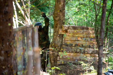 Paintball player resting from playing aroundの写真素材