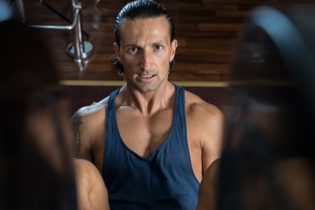 Man in gym on machine exercisingの写真素材