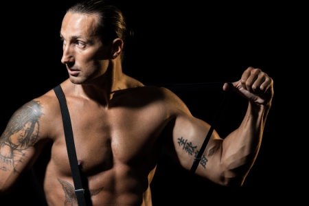 Sexy man with black suspenders over naked chestの写真素材