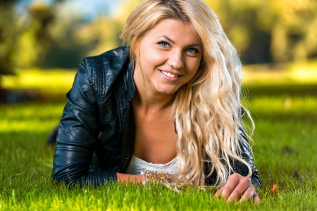 Girl Resting On Grass On A Sunny Dayの写真素材