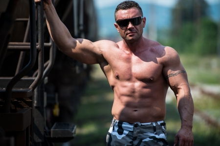 Man Athlete Holding On To Trainの写真素材