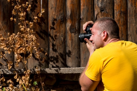 Young Man Taking A Photography With An SLR Cameraの写真素材