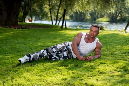 Bodybuilder Resting And Holding Water Bottleの写真素材