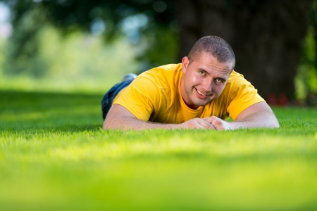Men Resting On Grass On A Sunny Dayの写真素材