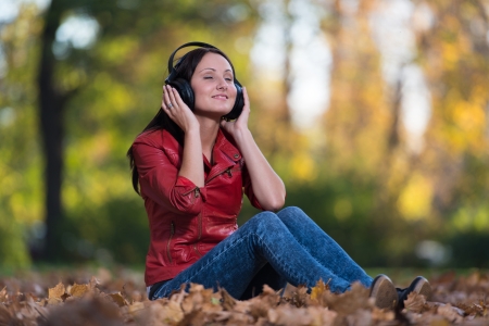 Young Woman Listening To Music In Natureの写真素材
