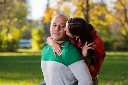 Young Man Giving His Girlfriend A Piggyback Rideの写真素材