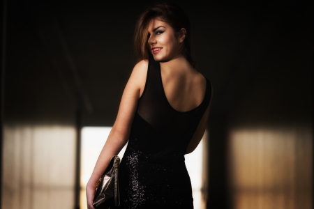 Fashion Model From Behind In Beautiful Black Dressの写真素材