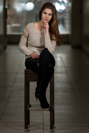 Beautiful Young Brown Model Sitting On The Chairの写真素材