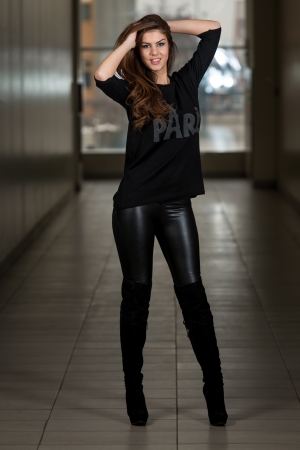 Young Woman Wearing Leather Pants And Long Sleevesの写真素材